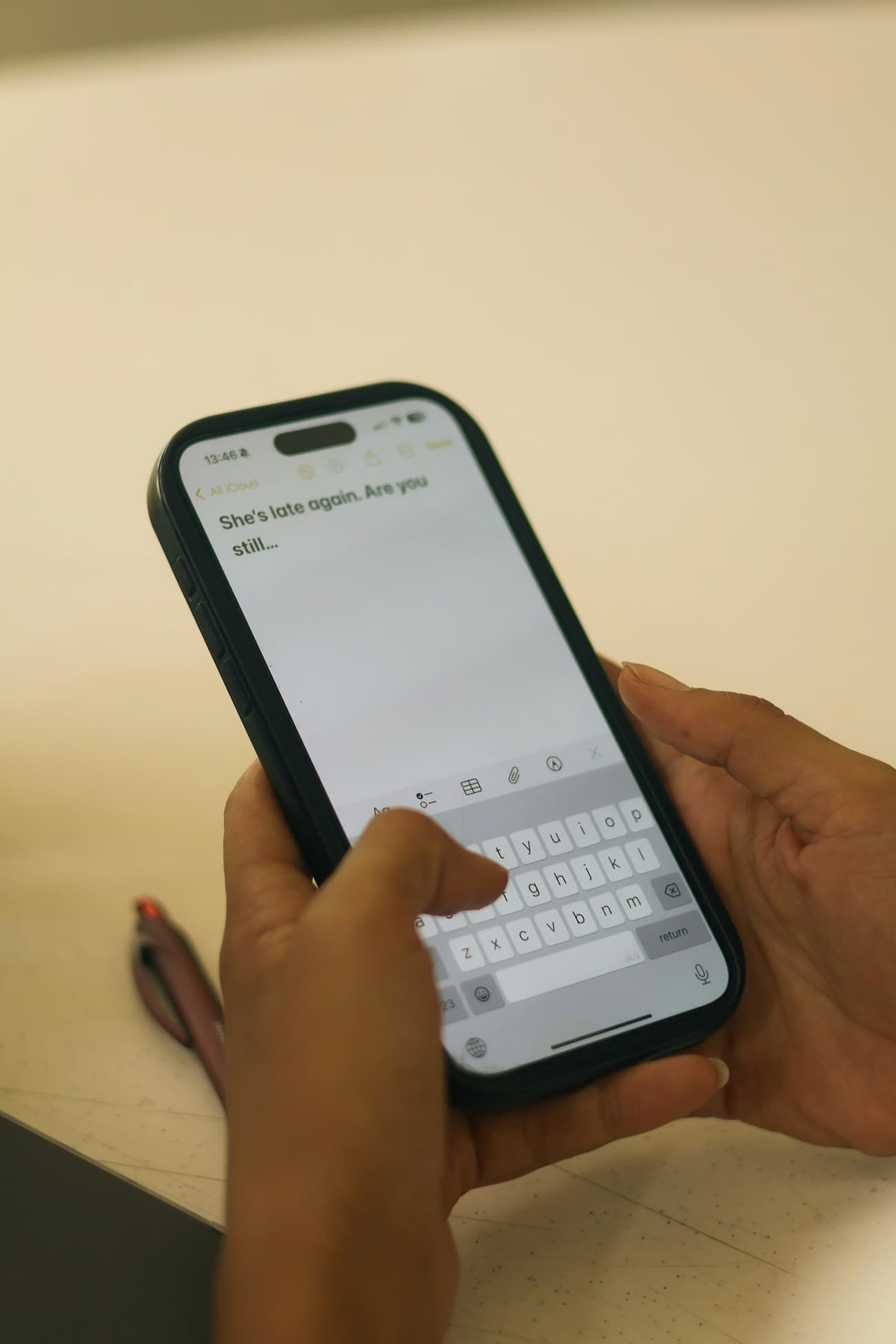 Hands typing a message on a smartphone