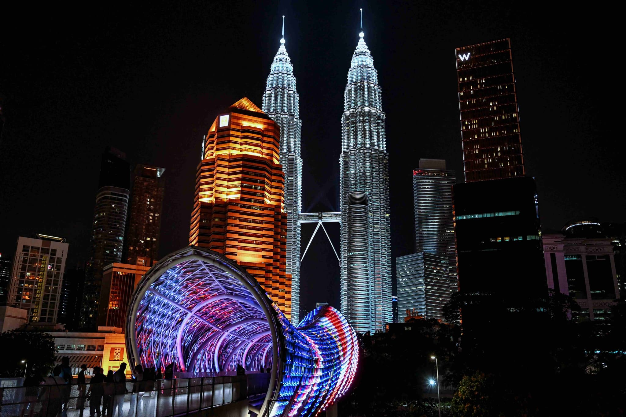 The Petronas Towers and the lit-up Saloma Bridge at night in Kuala Lumpur, one of Malaysia's best-known sights