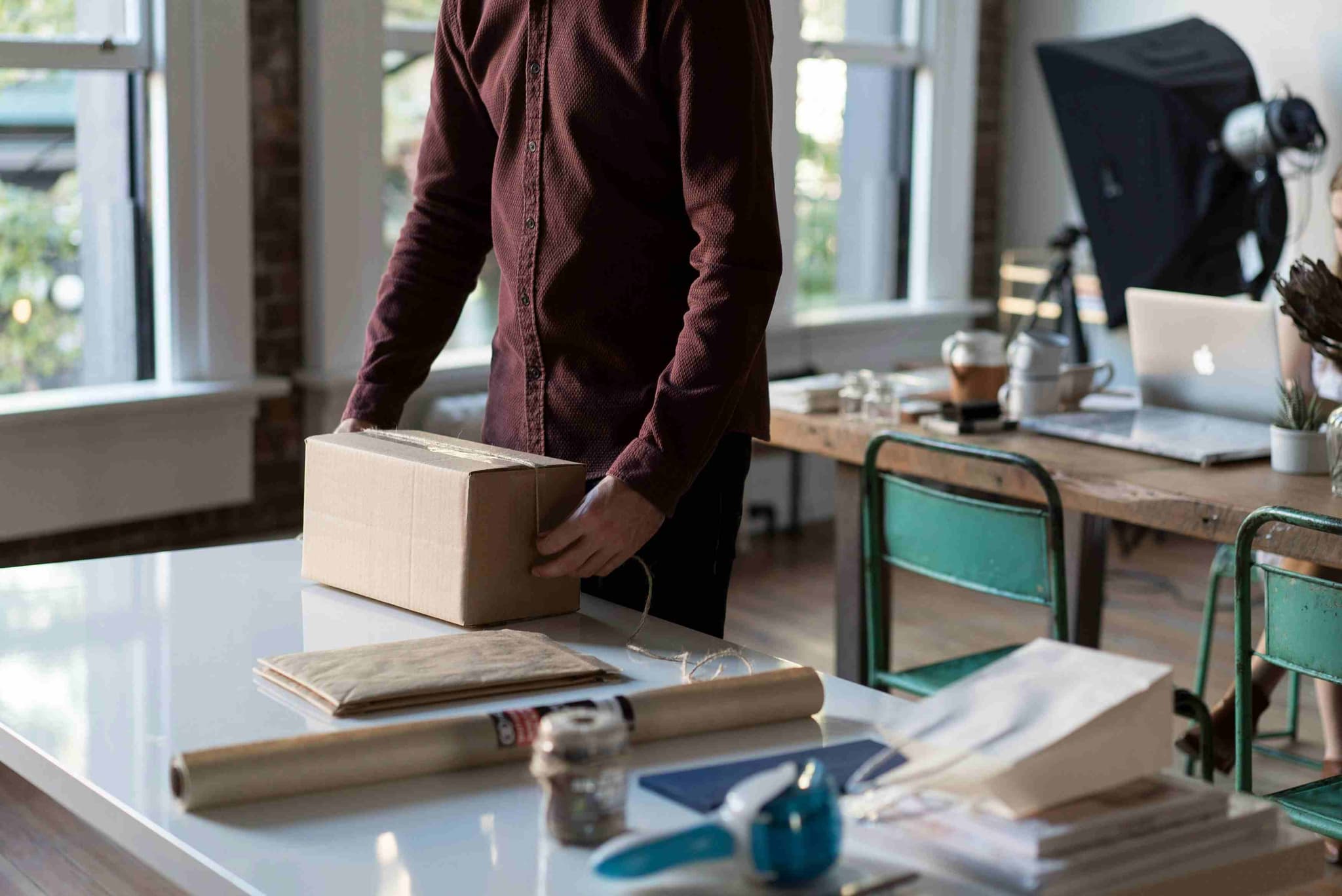 Someone packing a parcel to send with a traveler to another country